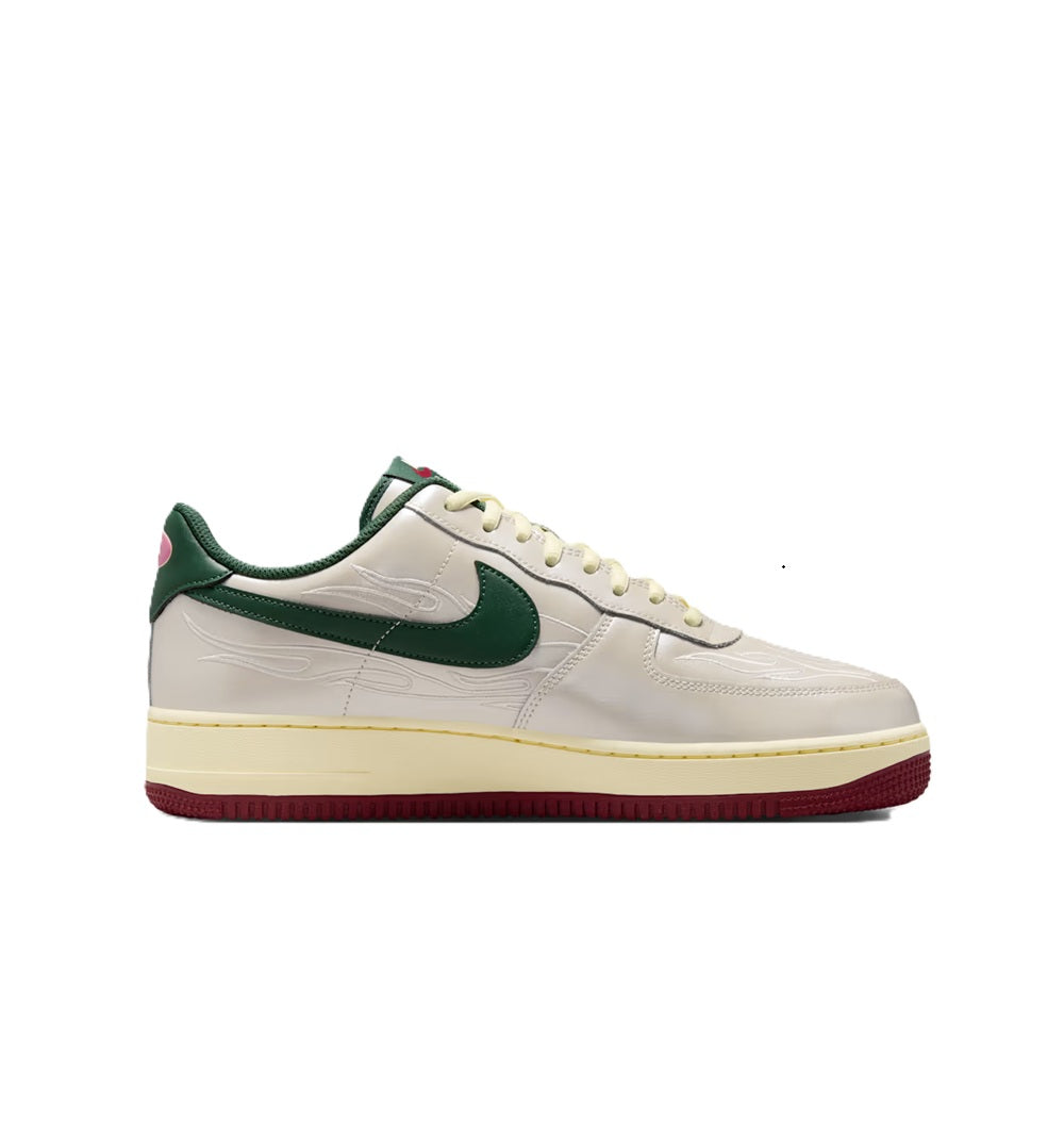 White low-top sneaker with green swoosh, lace-up front, and burgundy outsole