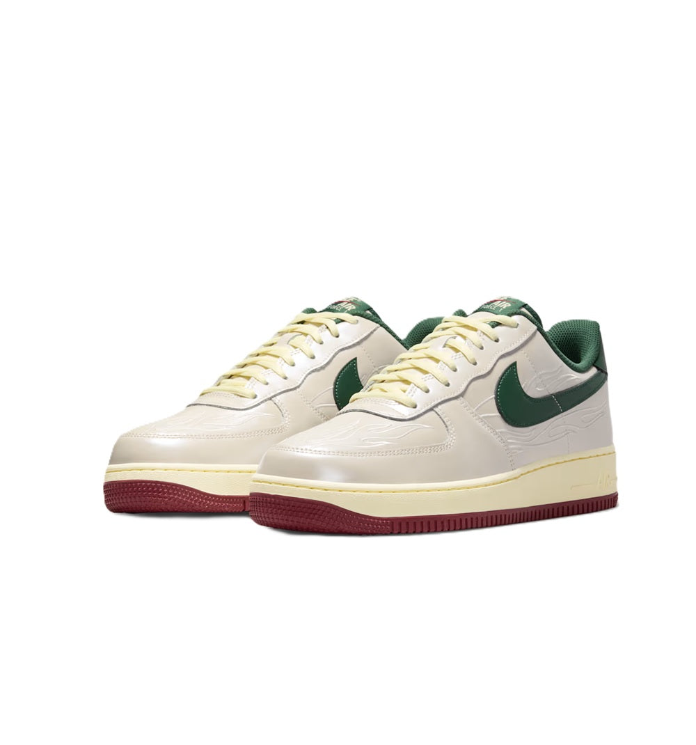 Pair of white sneakers with green swooshes and burgundy soles, side view