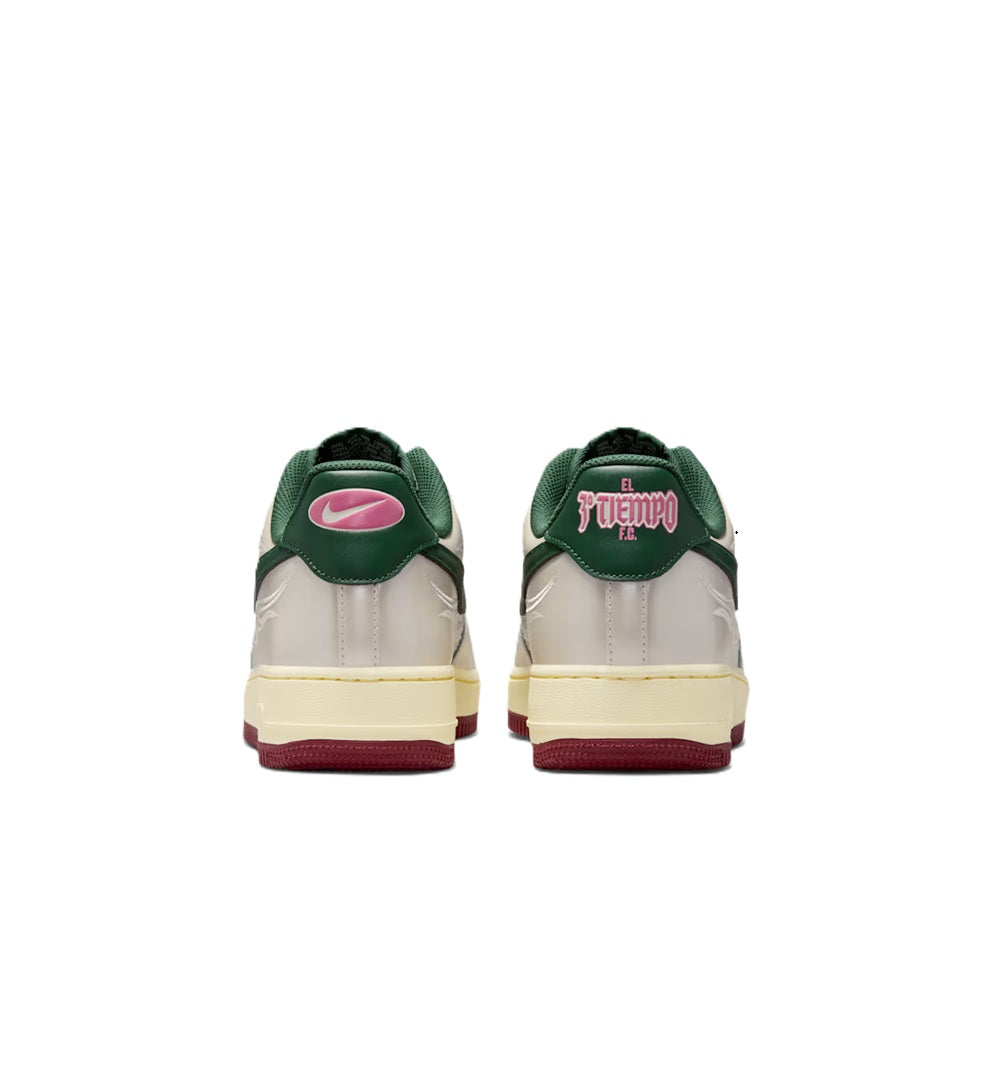 Back view of white sneakers with green heels and pink “Tiempo” logo