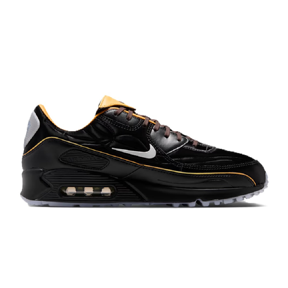 Nike Air Max sneaker: black upper, gold trim, visible air unit