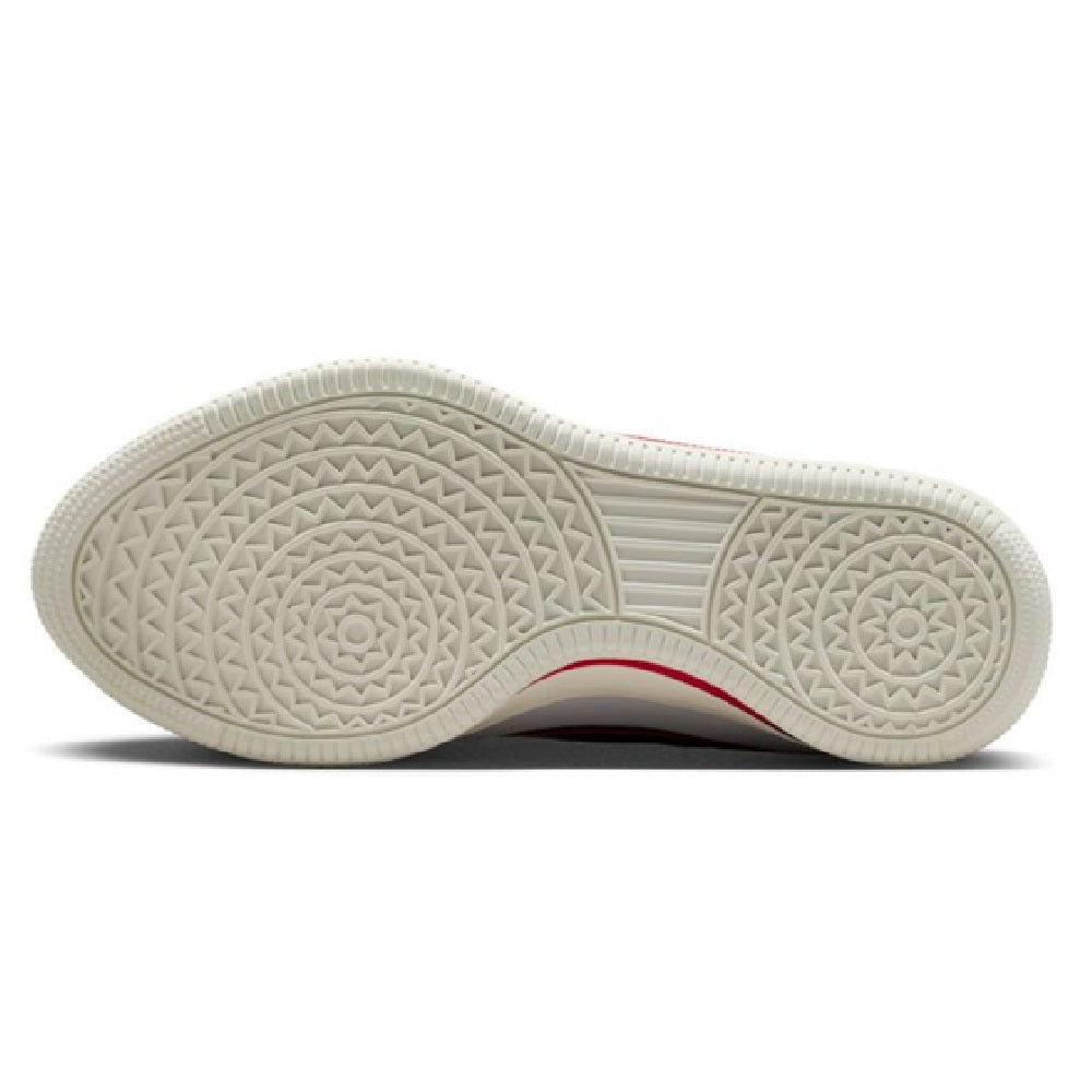 Rubber outsole of white low-top sneakers with textured traction pattern