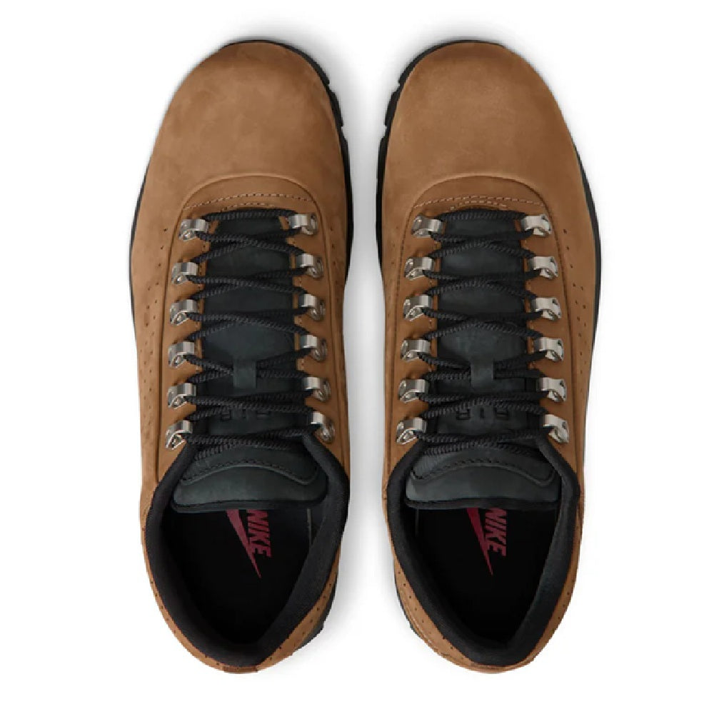 Men's sneakers with tan uppers and black laces, showing Nike tongue label and red swoosh