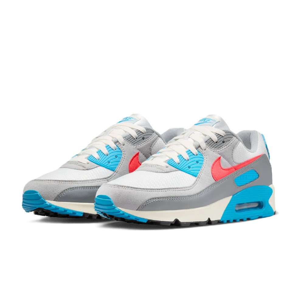 Pair of grey low-top Nike sneakers with blue accents, red swoosh, and Air unit sole