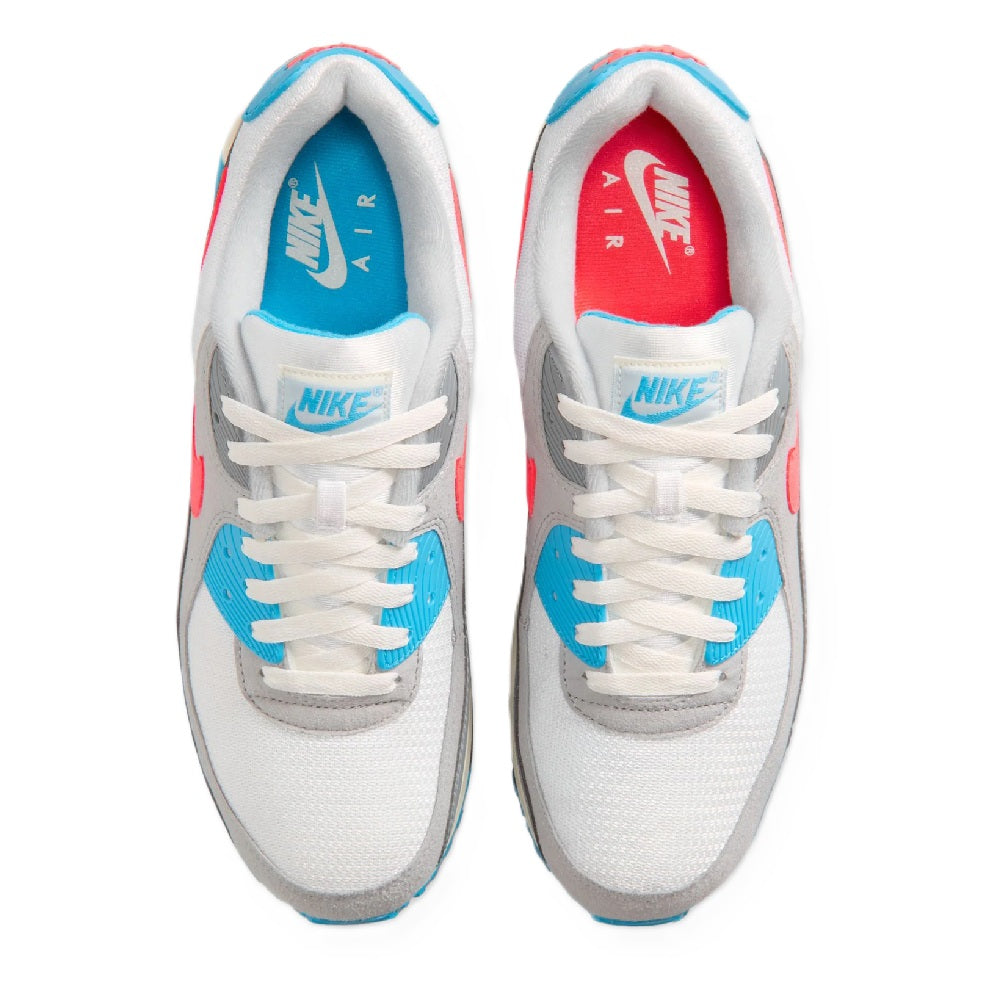 White laced sneakers showing tongue labels and inner lining with blue and red details