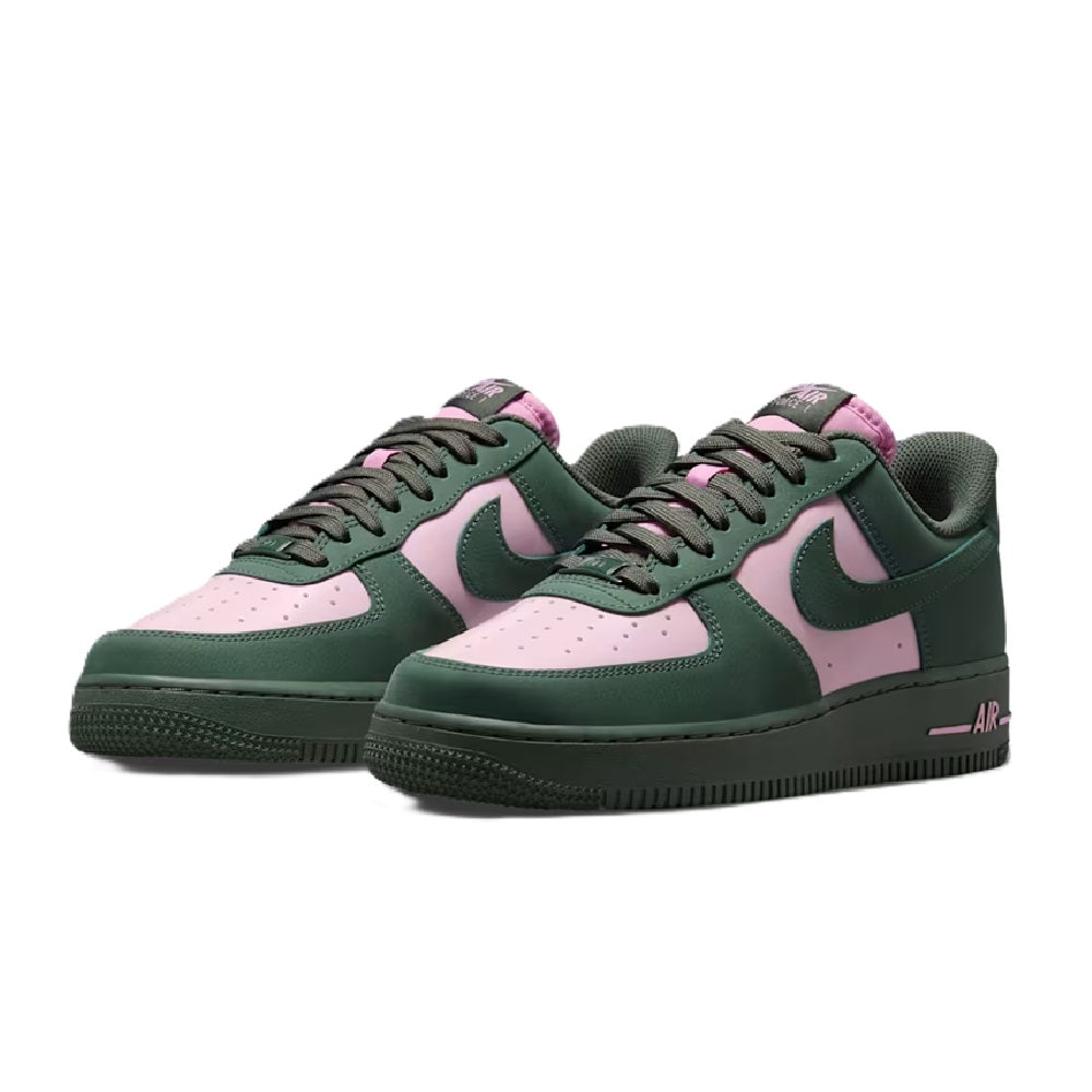 Pair of green low-top Nike Air sneakers with pink accents and lace-up
