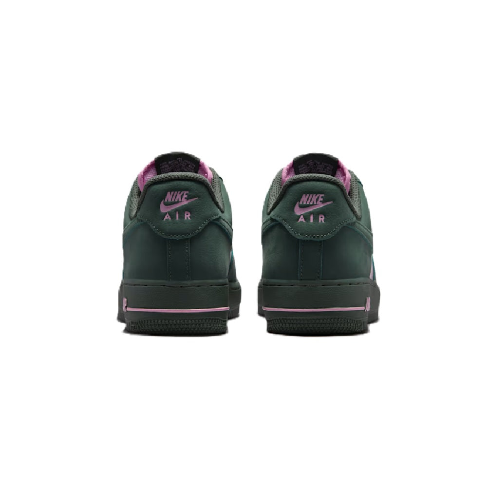 Back view of green Nike Air sneakers with pink heel lining and lace-up closure