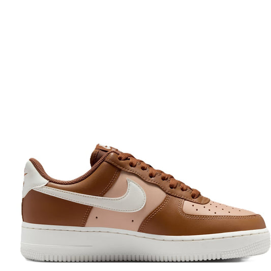 Tan and white low-top sneaker with white Swoosh and brown lace-up design