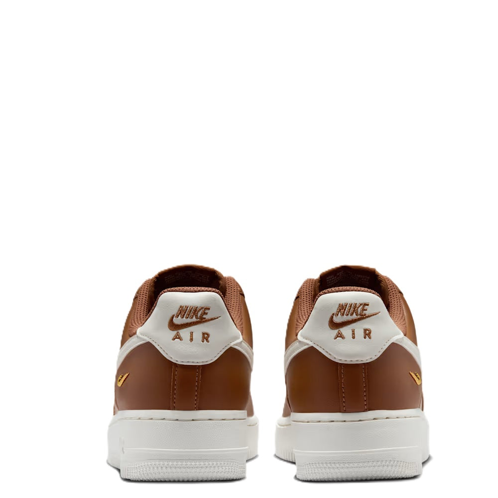 Back view of tan low-top sneakers with Nike Air logo on white heel tabs