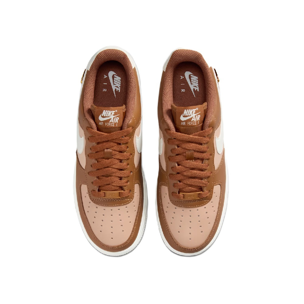Top view of tan low-top sneakers with brown laces and white toe panels