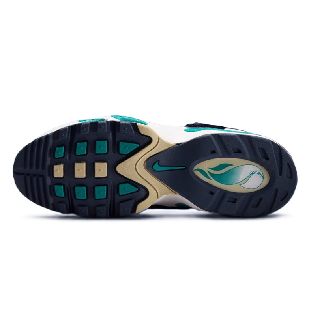 Rubber outsole of navy high-top sneakers with green traction pads and swoosh logo