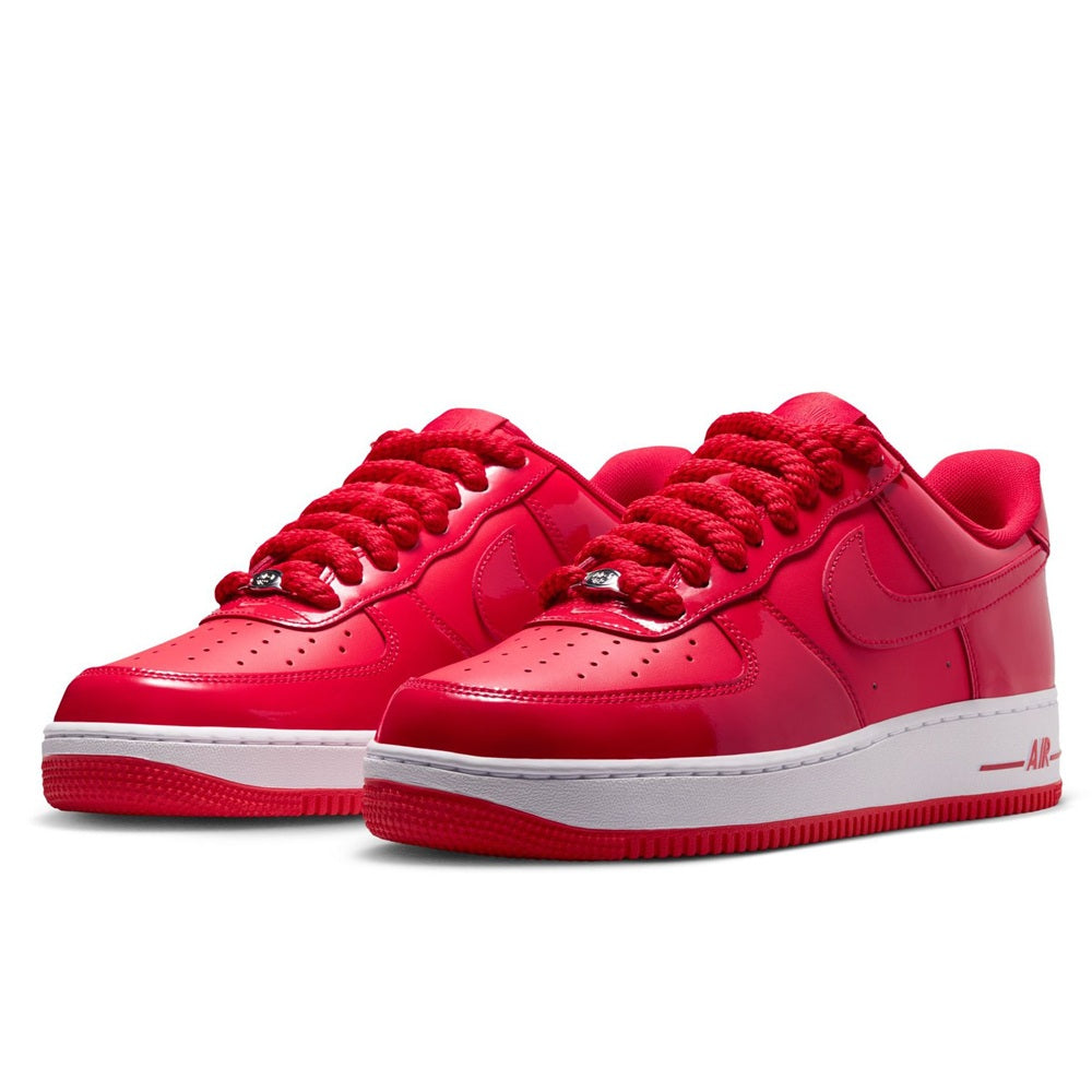 Pair of red Nike Air Force 1 low-top sneakers, lace-up with perforated toe, white midsole