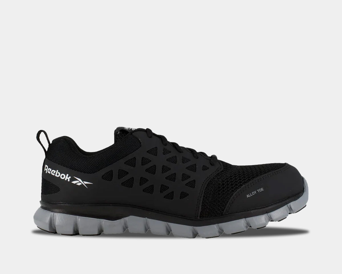 Black lace-up running shoe with Reebok logo, cutout upper, and gray cushioned sole
