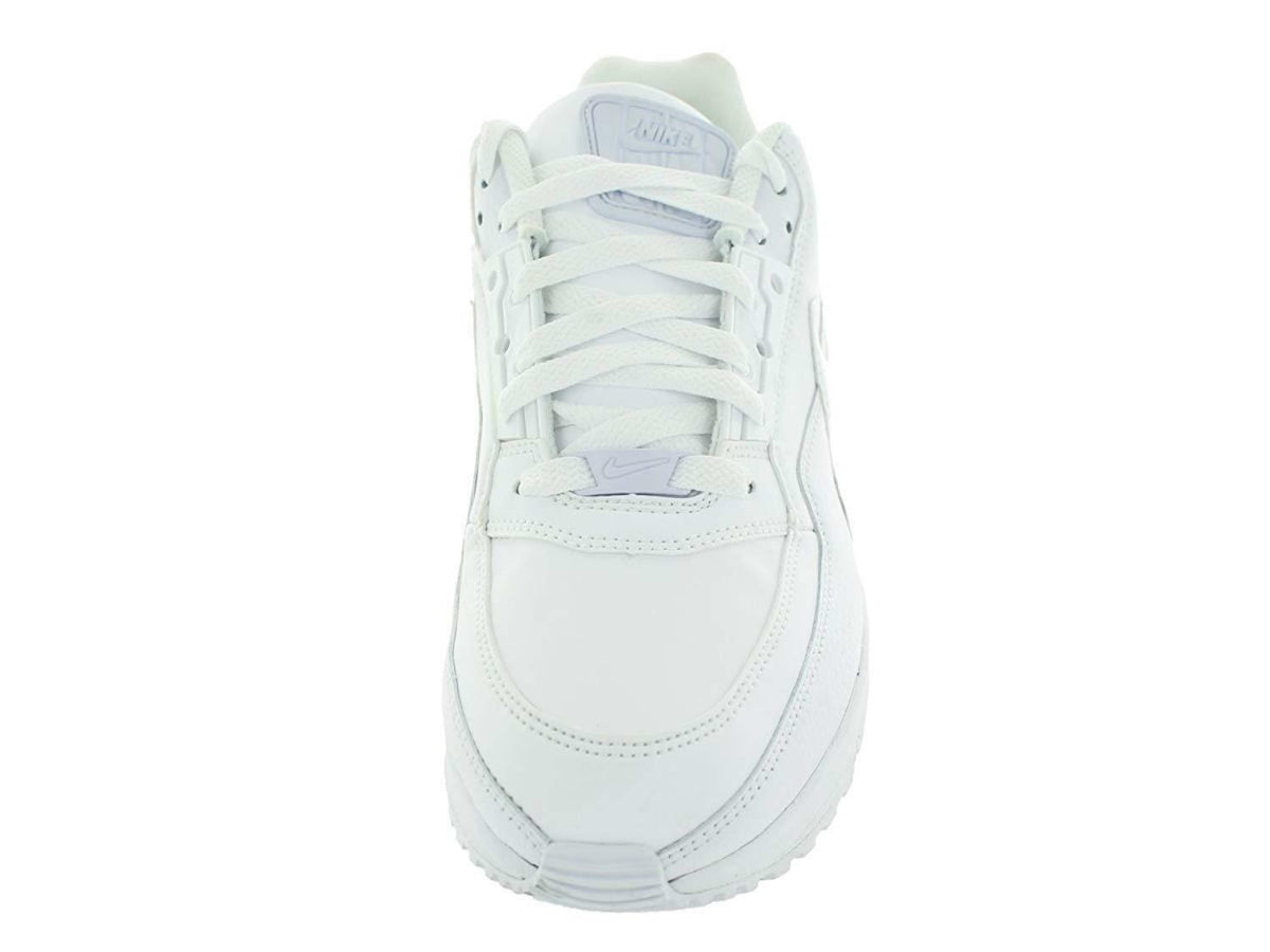White Nike low-top sneakers from front view with lace-up closure and stitching
