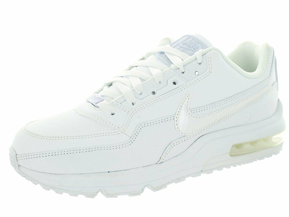 White Nike low-top sneakers with lace-up front and visible air-cushioned sole