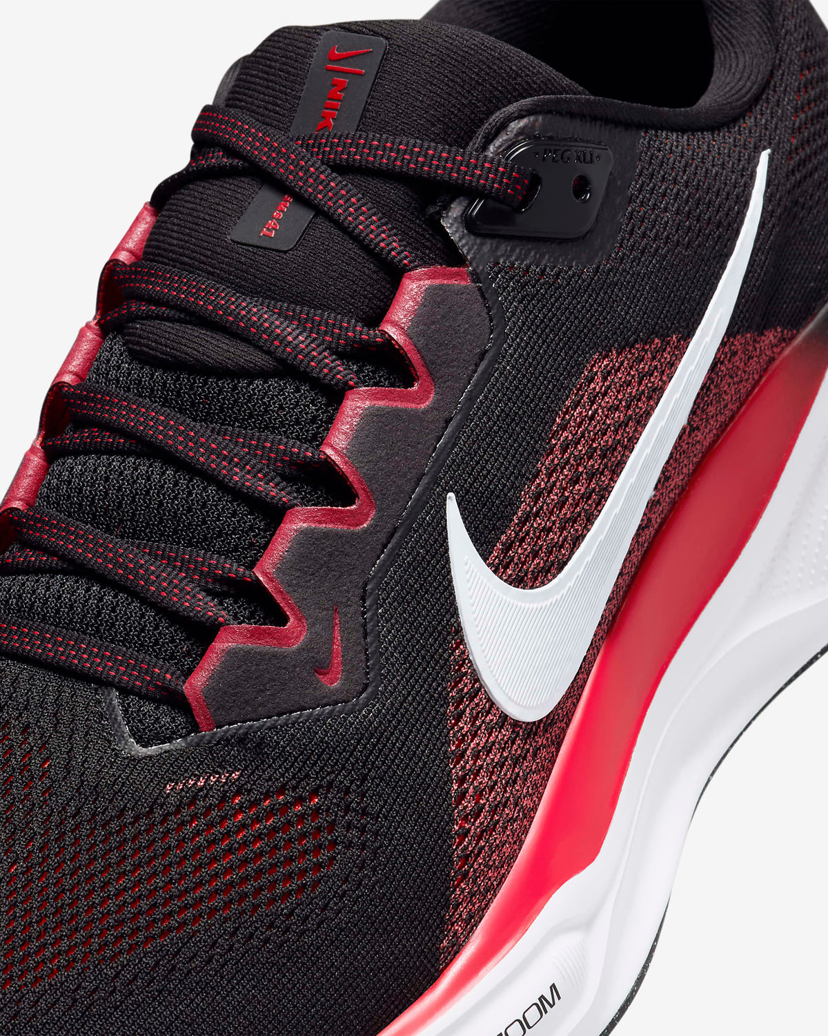 Black knit running shoe with red trim, white Swoosh, and Air unit sole