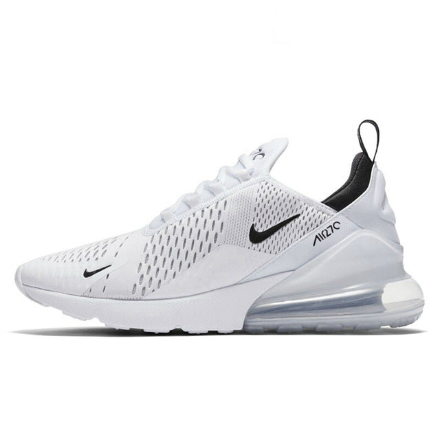 Running shoes with mesh upper, white with black accents, large silver-toned air sole unit.