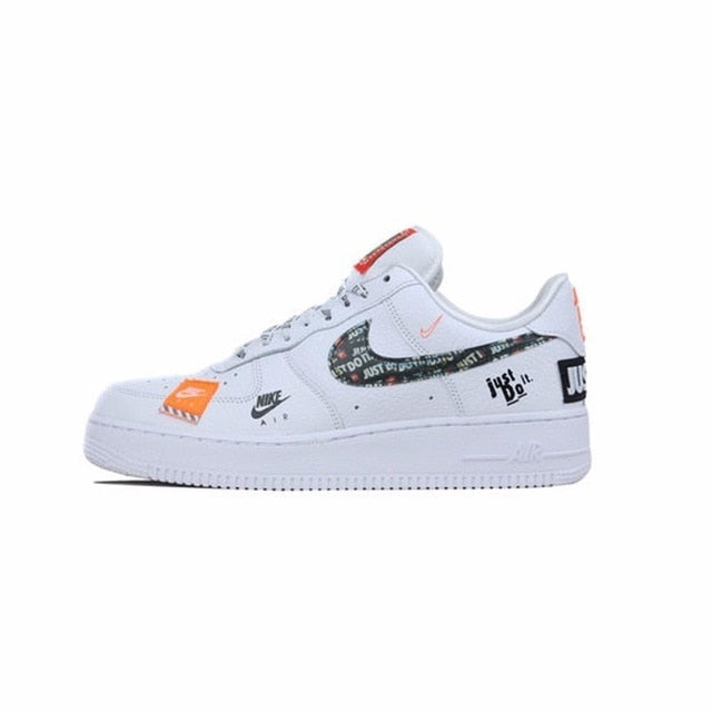 White low-top running shoes with Nike Swoosh, black heel tab, and orange accent