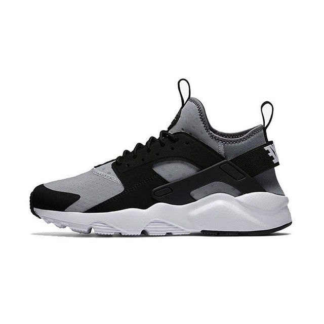 NIKE running shoe in black, gray, and white with white midsole