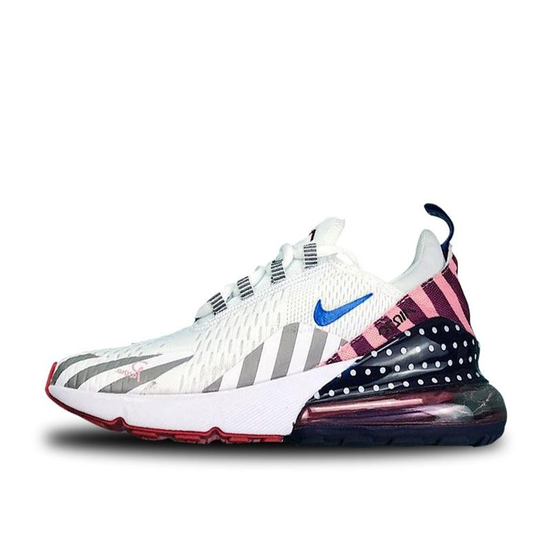 White running shoes with blue logo, gray stripes, pink and navy heel detail, lace-up