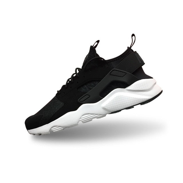 Nike Air Huarache running shoes in black with black strap and white midsole