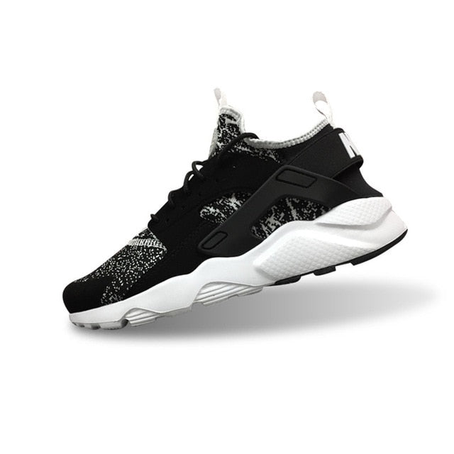 Nike Air Huarache running shoes in black with speckled details and white sole