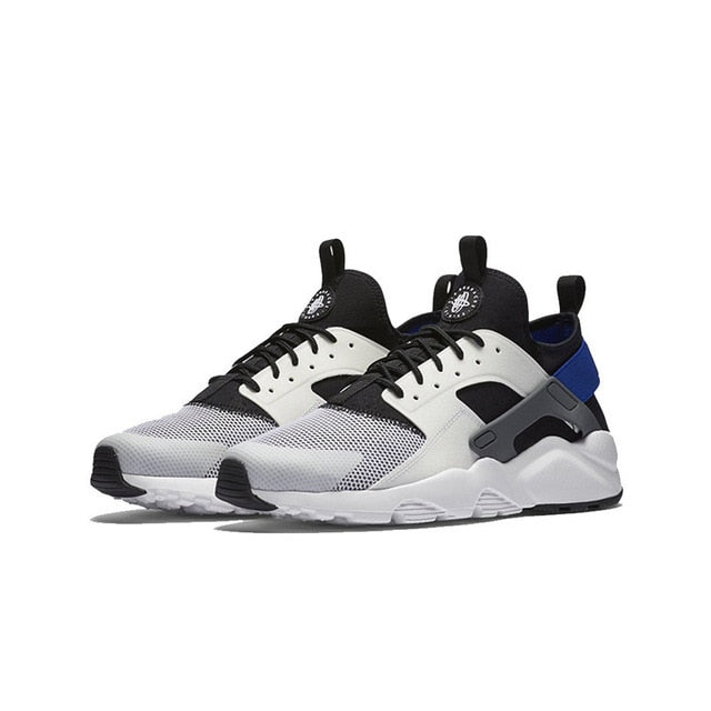 Nike Air Huarache running shoes in white, black, and blue with chunky white sole