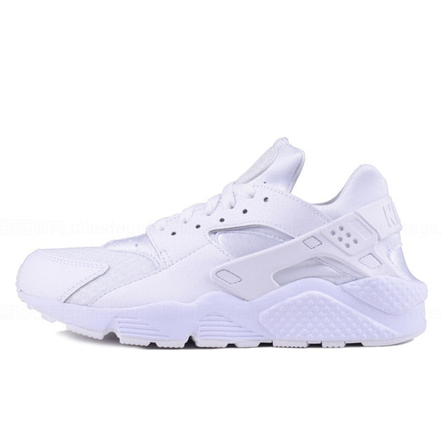 Nike Air Huarache running shoes in white with perforated upper and white sole
