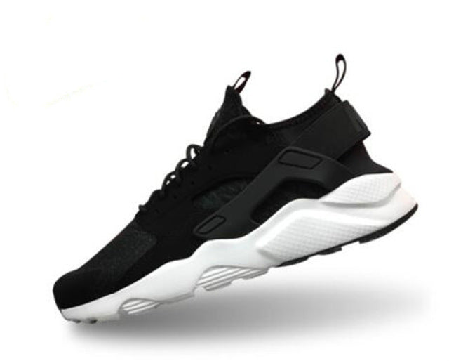 Black running shoes with white sole and gray side panels, hook-and-loop strap