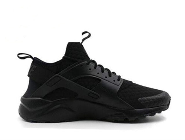 All-black running shoes with chunky sole, lace-up front and molded side cage