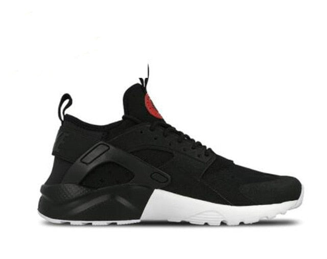 Black running shoes with small red heel accent, chunky white midsole detail