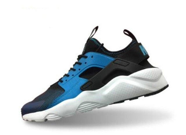 Blue and black running shoes with white sole, lace-up front and hook strap