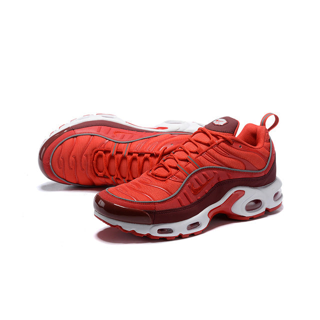 Red running shoes with cushioned knit upper and visible Air unit sole