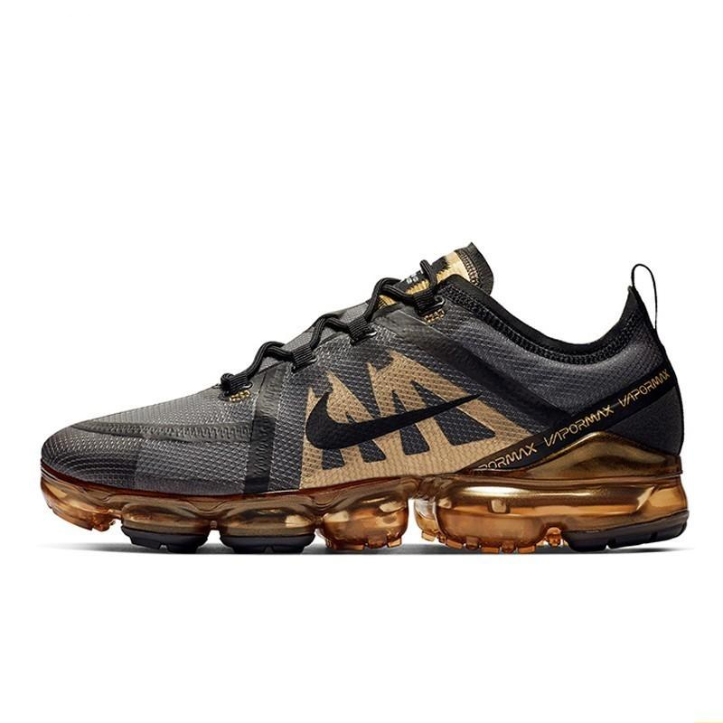 Nike Vapormax running shoes with gray mesh upper, gold swoosh, and visible air sole