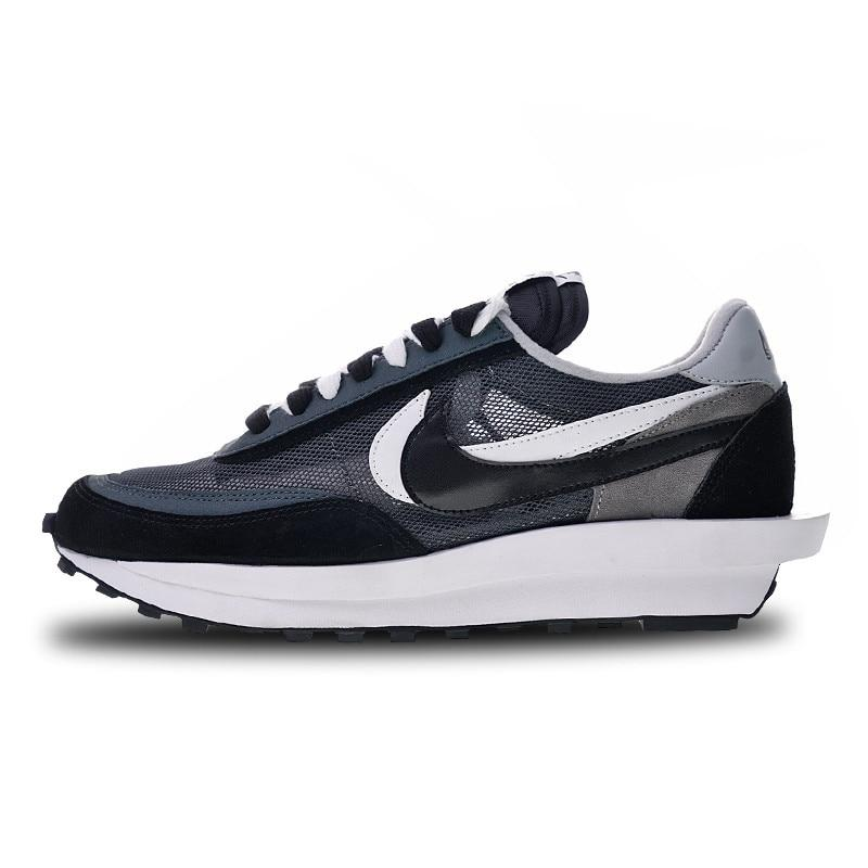 Dark blue and black running shoes with white midsole and grey/black swoosh