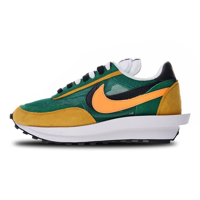 Green, orange, and yellow running shoes with white midsole and multicolor swoosh