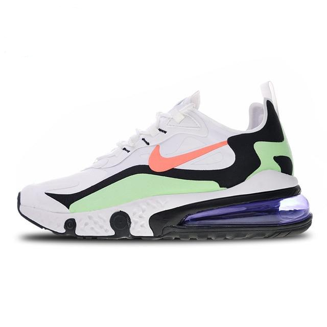 White running sneakers with orange swoosh, green accents, and purple heel air window