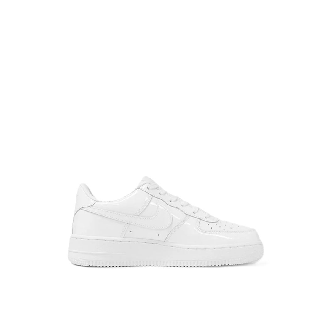 White kids low-top Nike sneaker, lace-up with swoosh and perforated toe