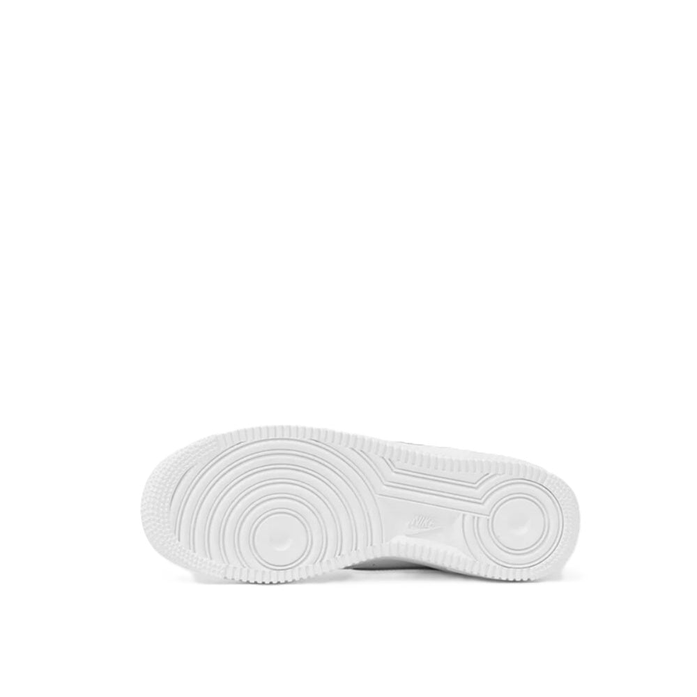 White kids Nike sneaker outsole, textured rubber tread underside